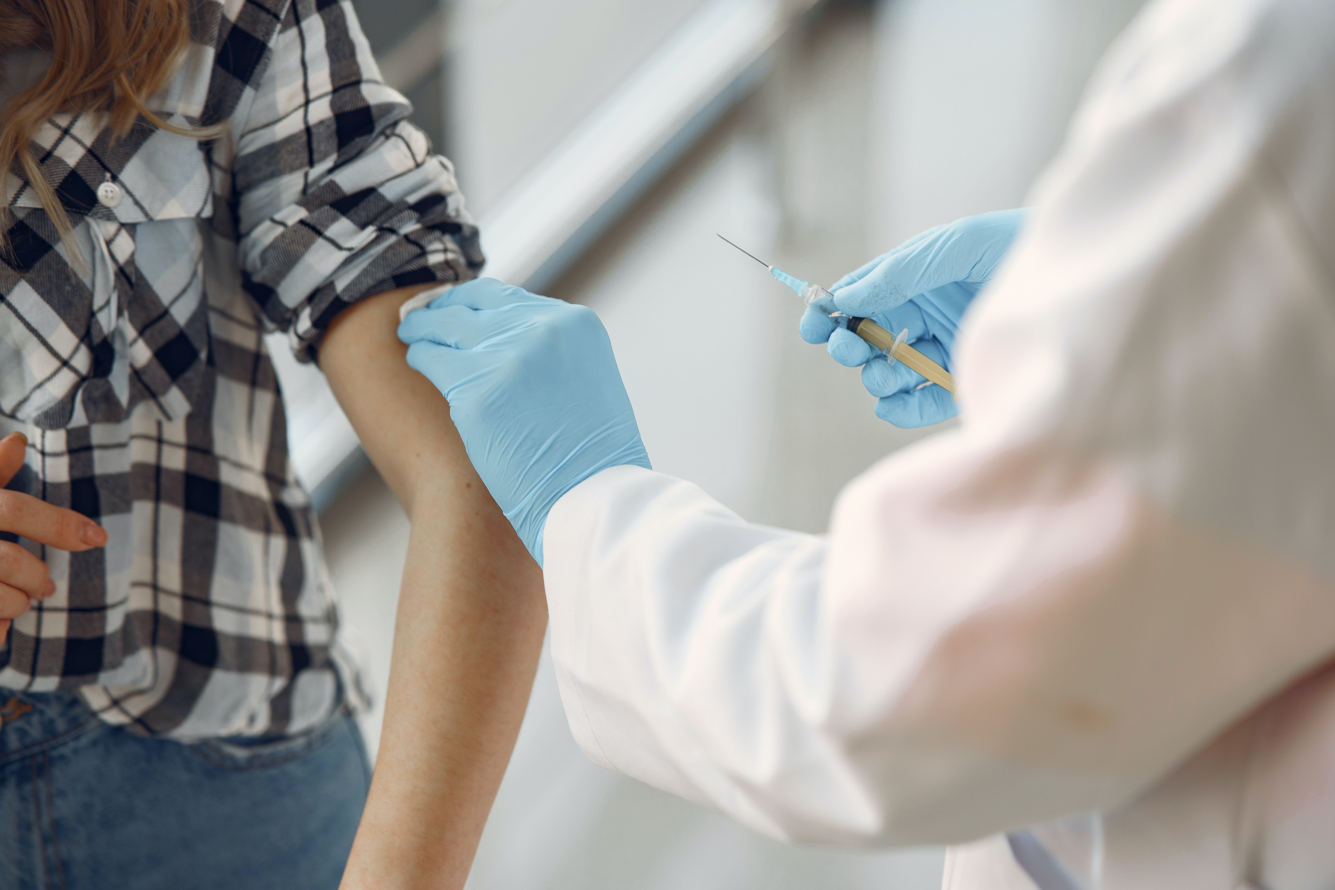 Doctor giving a vaccine to a patient